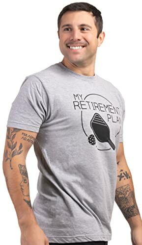 Man wearing a gray t-shirt with 'My Retirement Plan' and pickleball graphic.